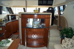 forward view of the salon, leading to the pilot house to stbd, and to the galley and the staterooms off to the port side