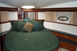 The guest stateroom - with independent heating / air conditioning, a TV, and (obviously) it's own closet space - including storage beneath the bed - with an opening port overhead